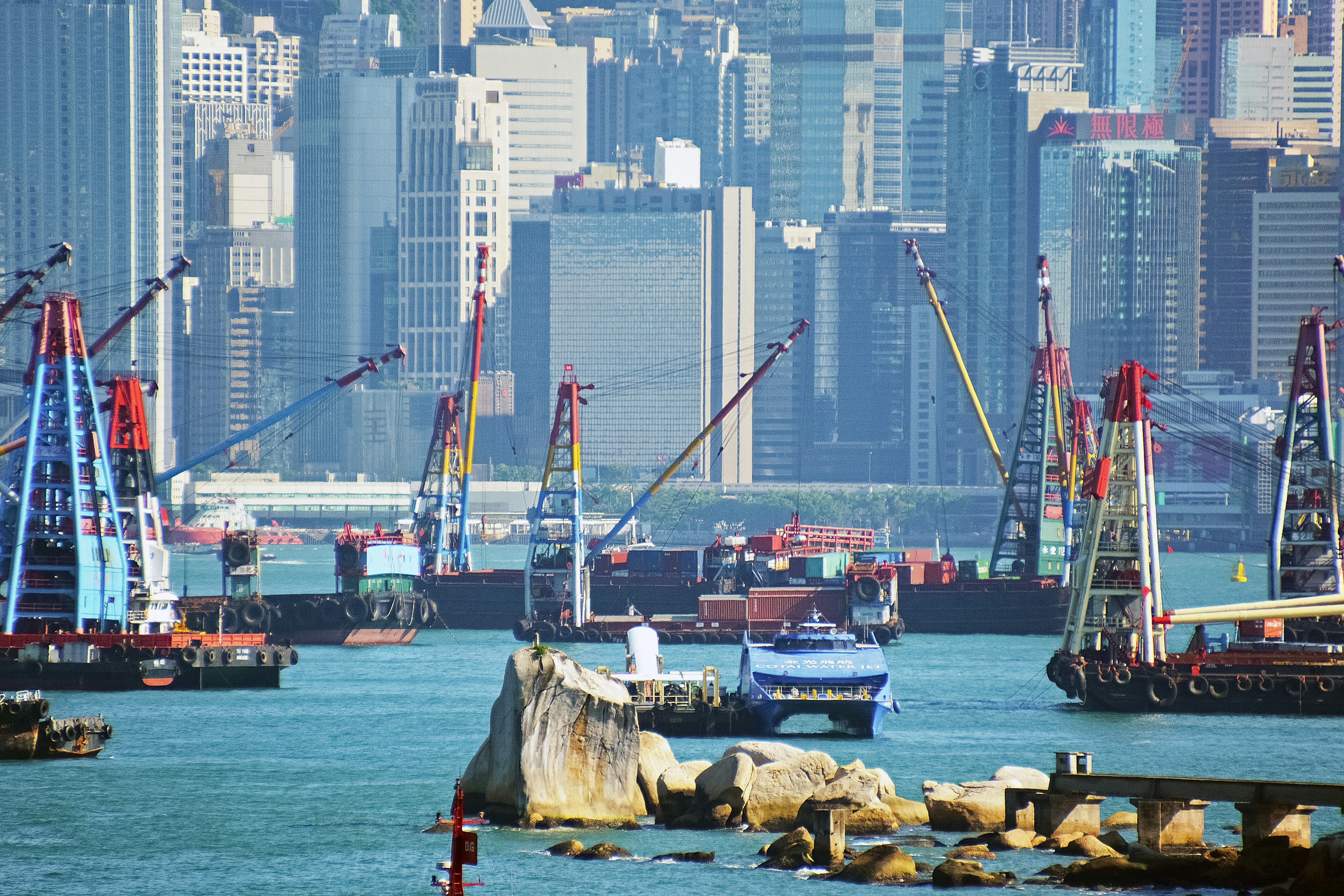 red and white ship on sea near city buildings during daytime